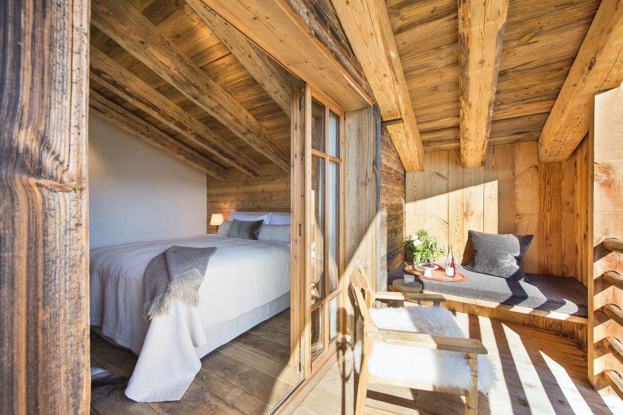 Master bedroom with private balcony at Chalet Aline in Verbier